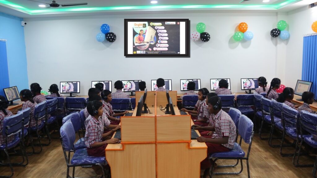 Students engaged in digital language lab classroom equipped with computers and headsets in Language Lab Classroom in Govt High School Zphs Husnabad