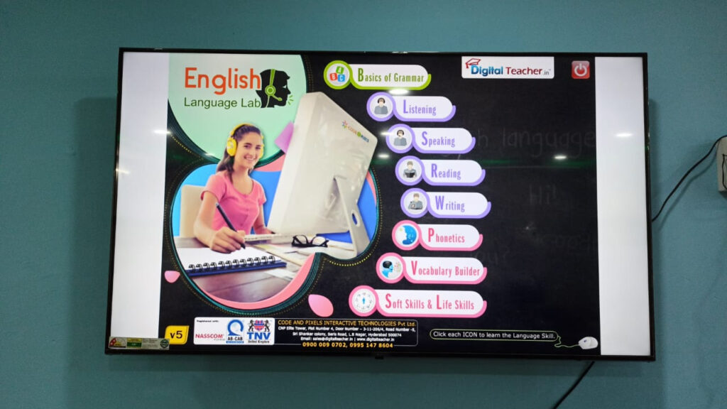 In a Govt School Lab Tv Screen Screenshot of the English Language Lab interface with tools for learning English, featuring a student with headphones and Digital Teacher branding.