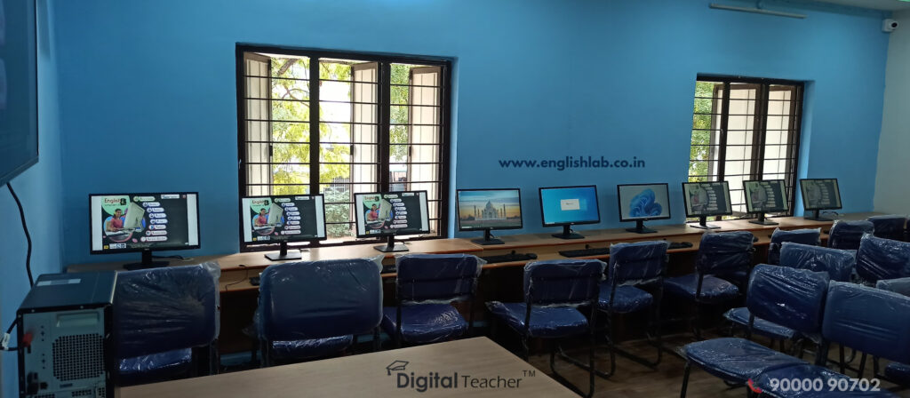 Modern computer lab with multiple workstations featuring educational software, blue walls, and large windows providing natural light, designed for digital lab learning and language training at an educational environment.